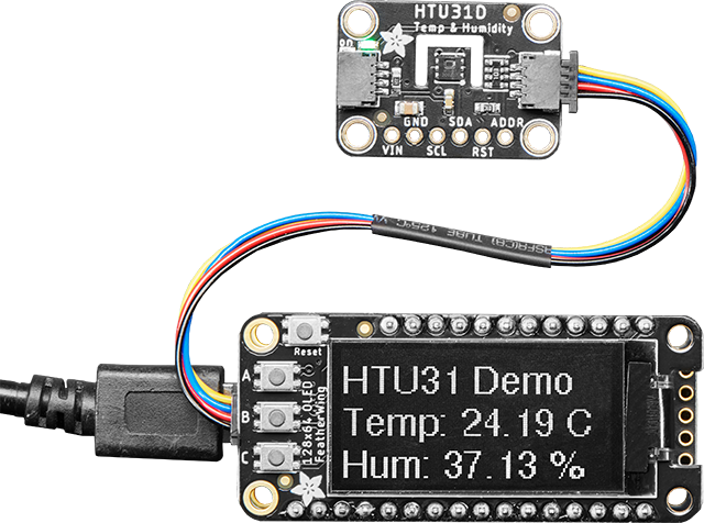 HTU31D Temperature and Humidity board connected to an OLED FeatherWing with STEMMA cable showing the temperature and humidity readings.